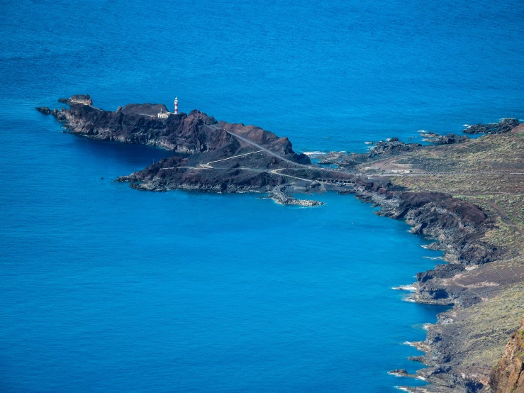 an aerial po of a large island next to the ocean