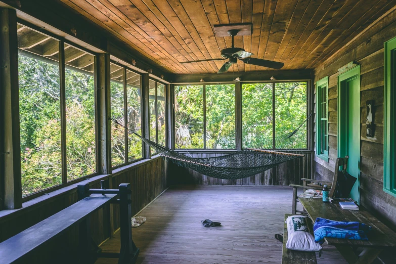 a porch is shown with hammock and windows