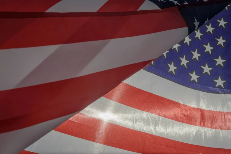 two american flags are pictured in the dark