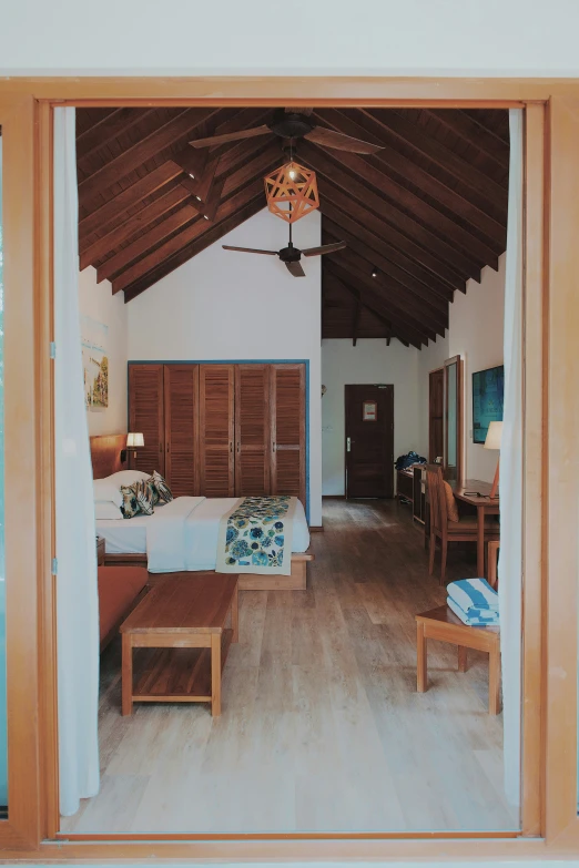 the interior of a bedroom with a ceiling fan