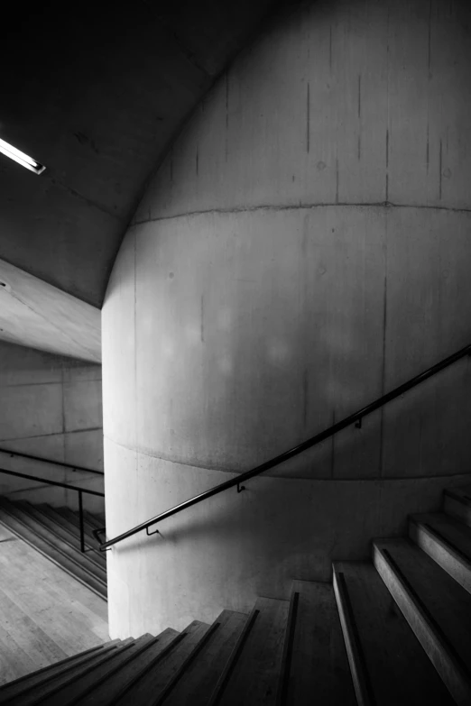 an empty hallway with a handrail and steps