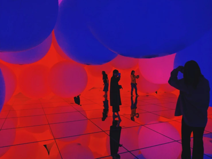 an installation of balloons that are colored purple and orange