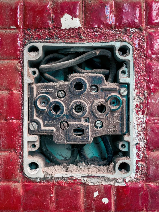 the exposed hole in a red brick wall