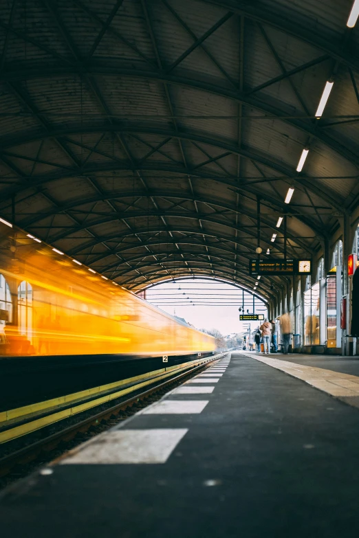 a train moving along the tracks at a train station