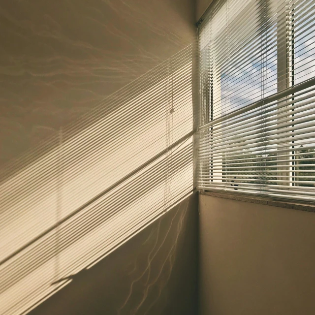 window blinds and blinds are shown against a tan wall