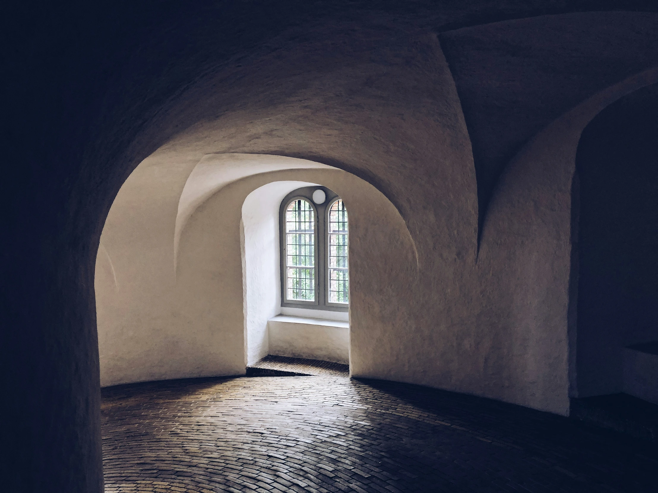 the interior of an arch in a stone building