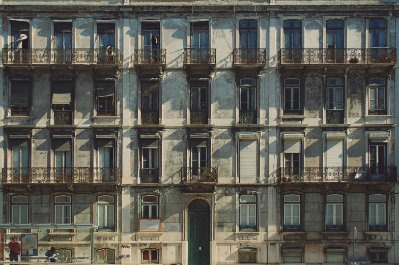 the building has multiple balconies on its windows