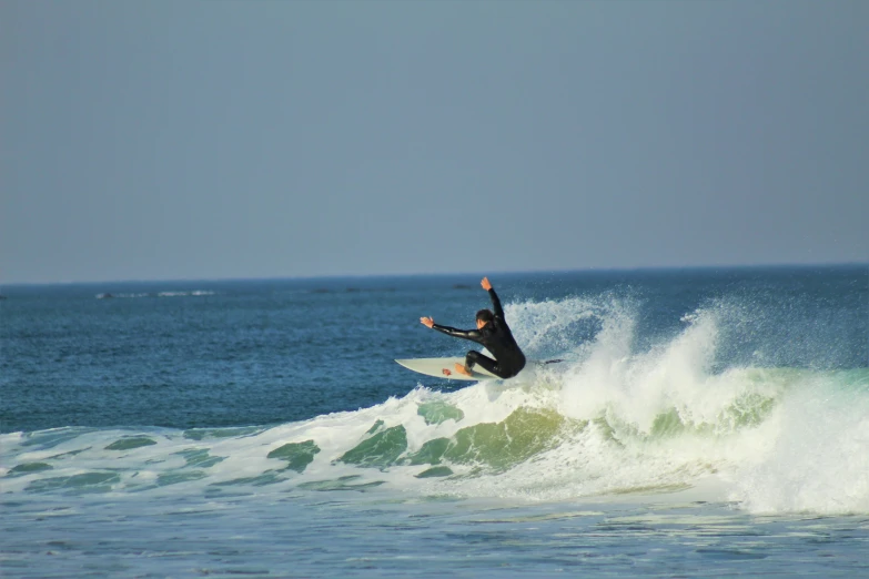 a man is riding on the waves on his surfboard