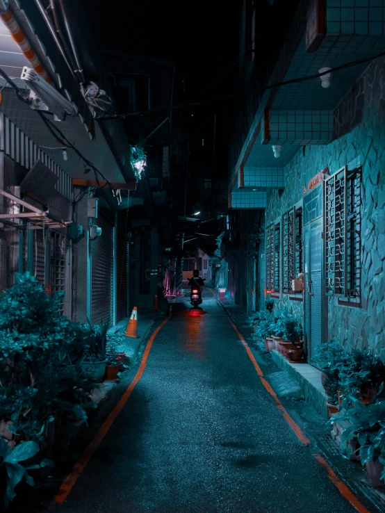 a street with a car parked between two buildings