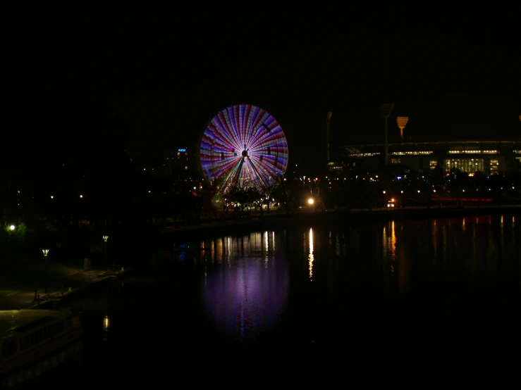 a large ferris wheel on a dark city street