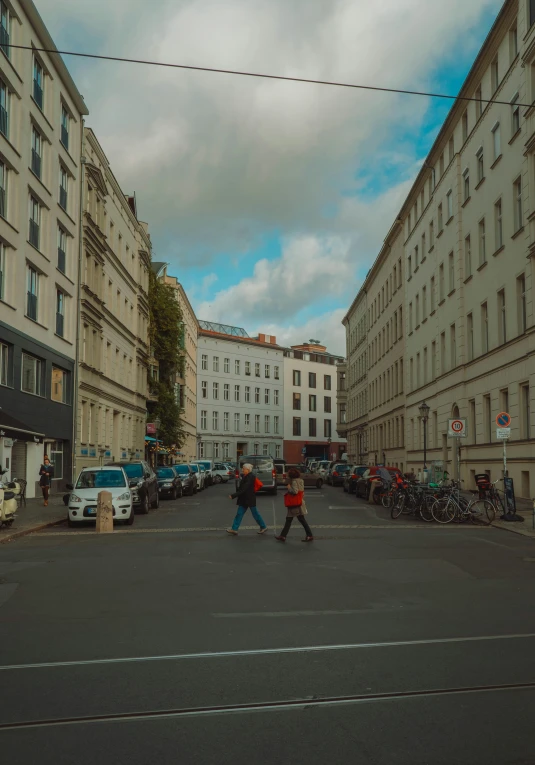 there are people walking down the road in town