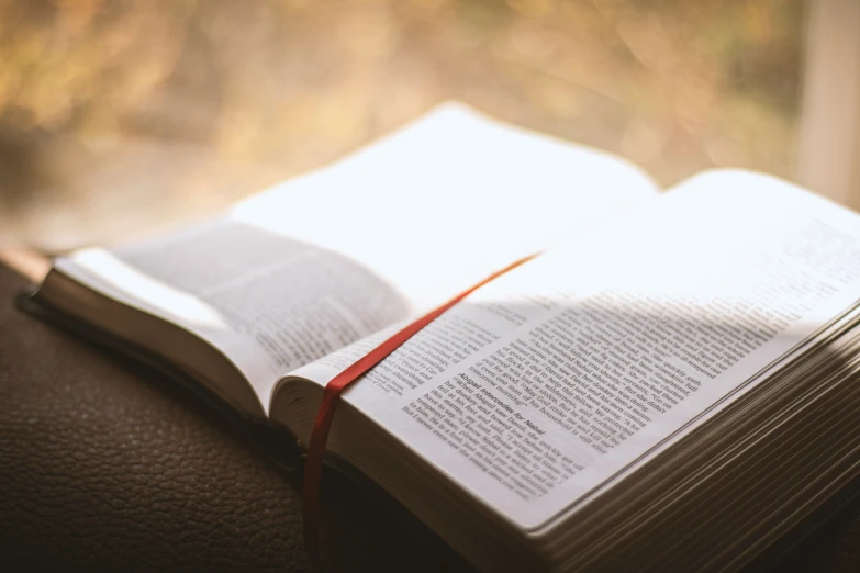 open book on a leather table with blurred backround