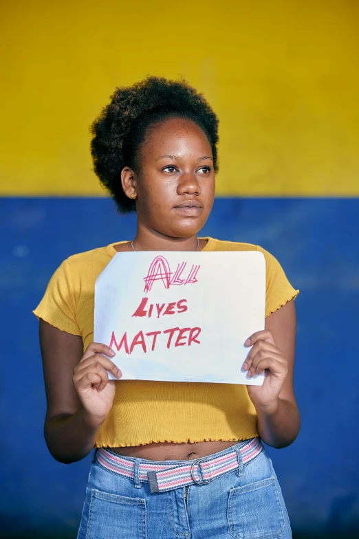 a young woman holds up a sign that reads always has matter