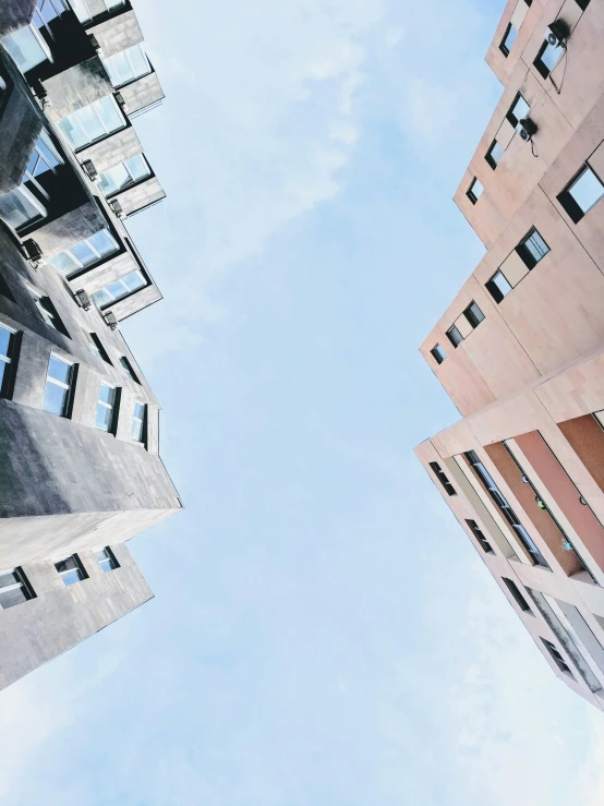 the bottom of some tall buildings looking up