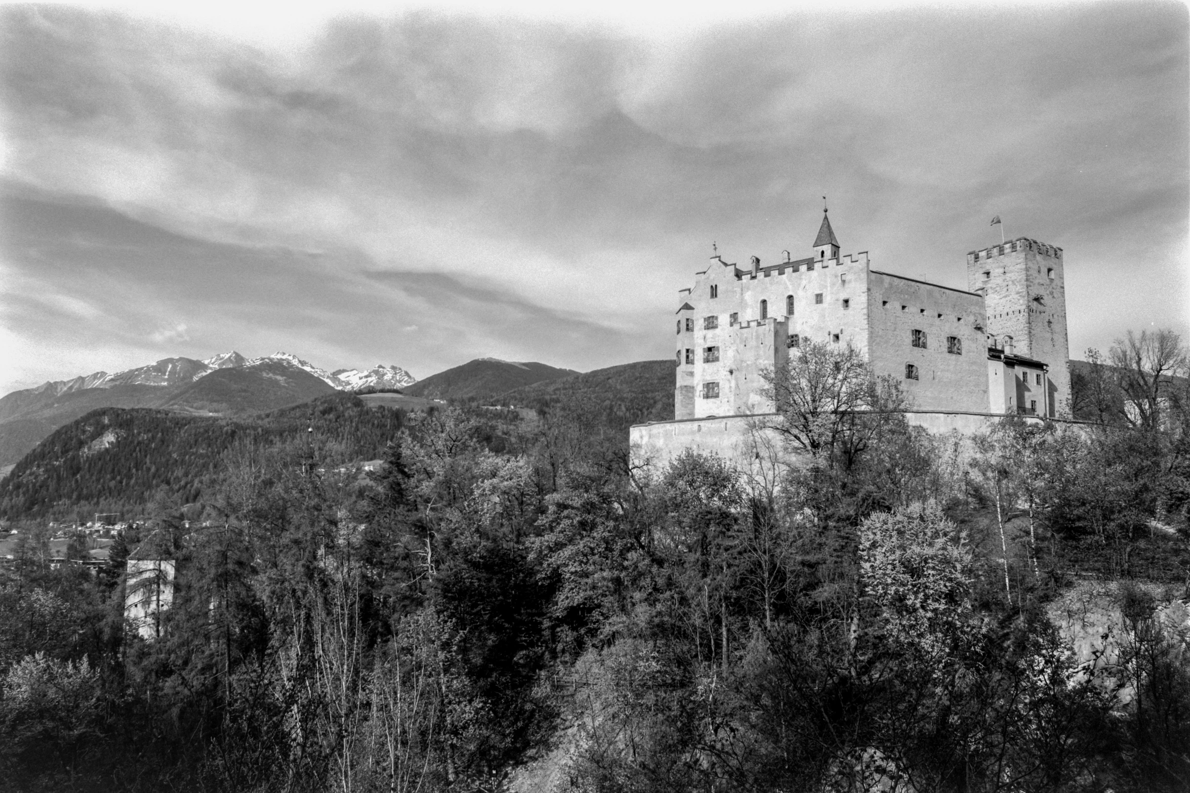 this image shows an old castle perched high on a hill