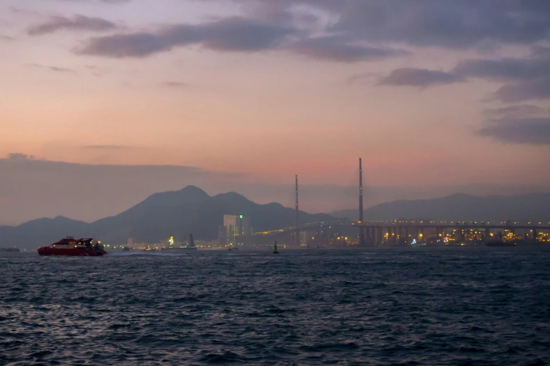 a distant po of a red boat in a body of water