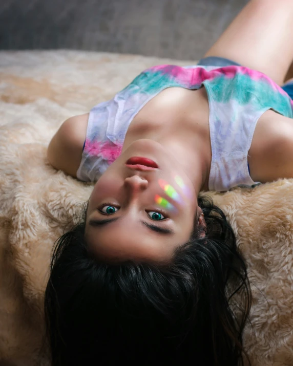a girl in colorful clothes laying on her stomach