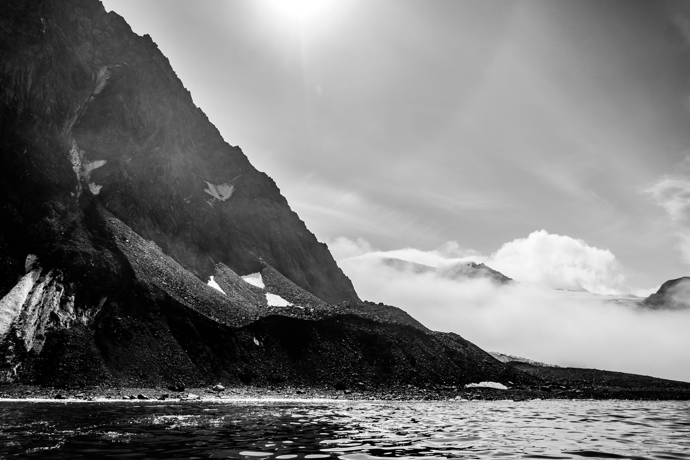 a mountain with a body of water in front of it