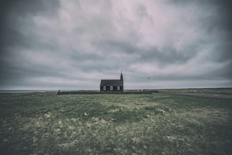 an image of a small church surrounded by green grass