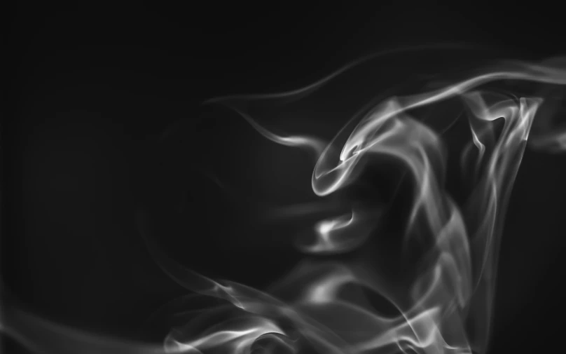 smoke is moving across the screen in the dark