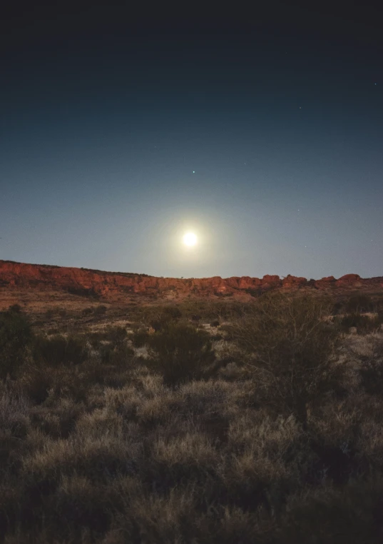 a very bright sun shines over the desert and landscape