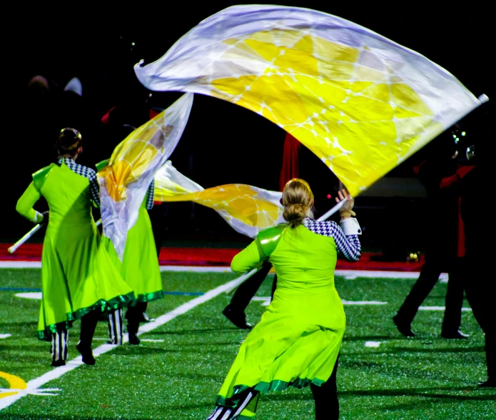 two women holding and dancing on the field