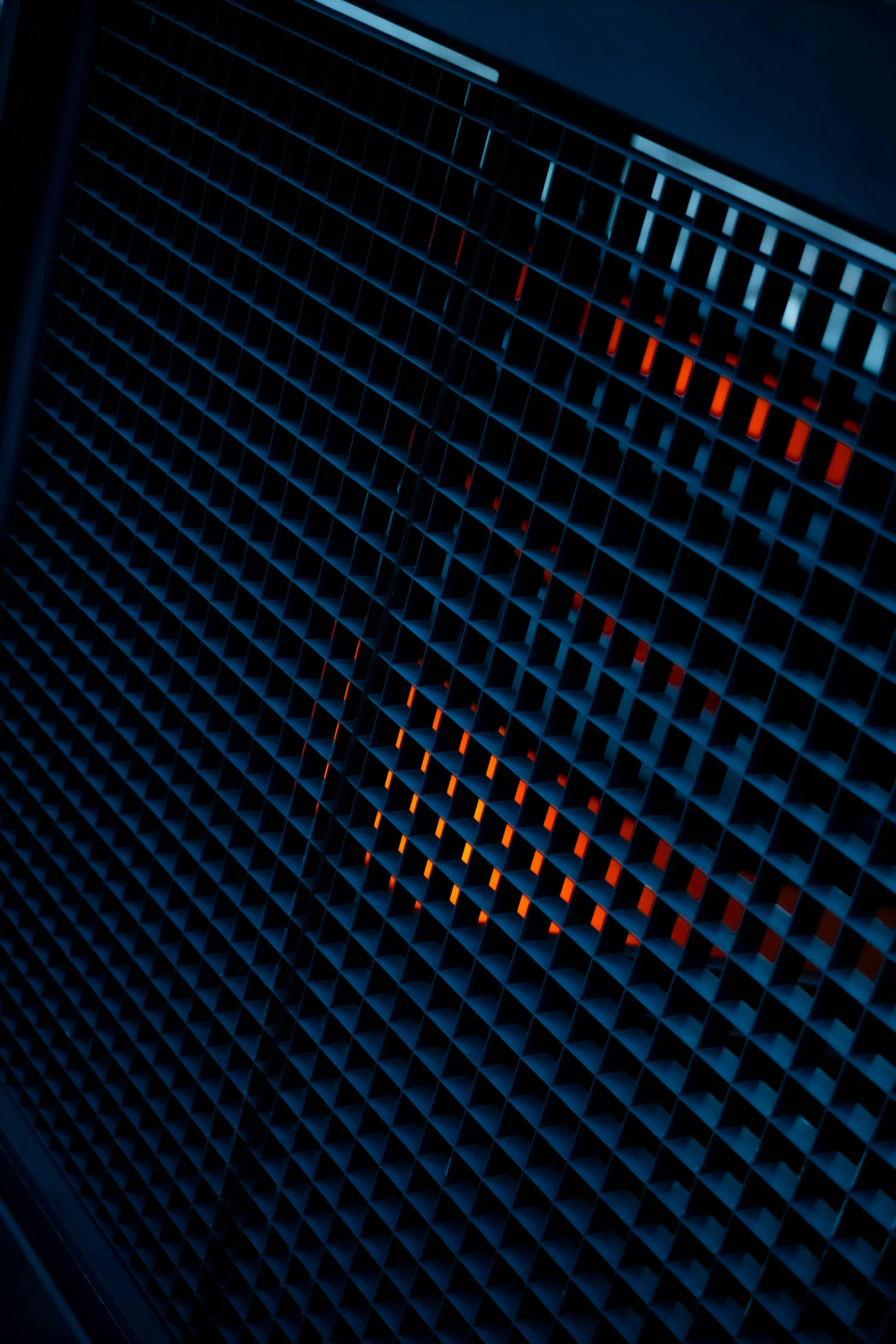 the image of an open metal grill with red lights inside