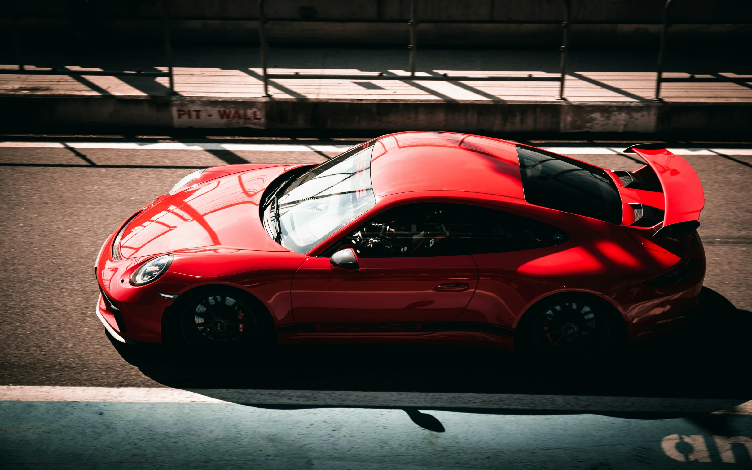 the top of a red sports car driving down the road