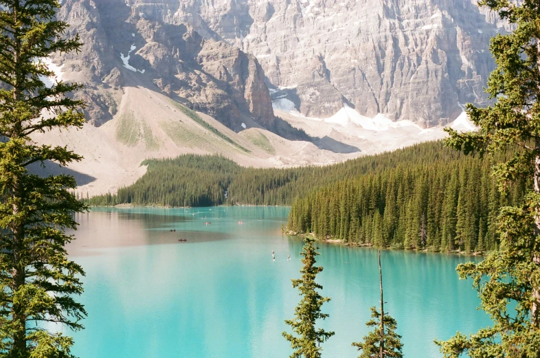 mountains with blue waters and trees around it