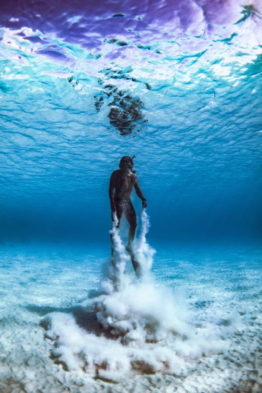 a man with a camera in his hands under the water
