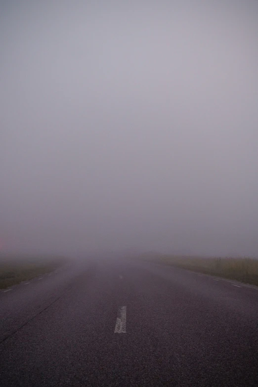 a foggy street in a rural area
