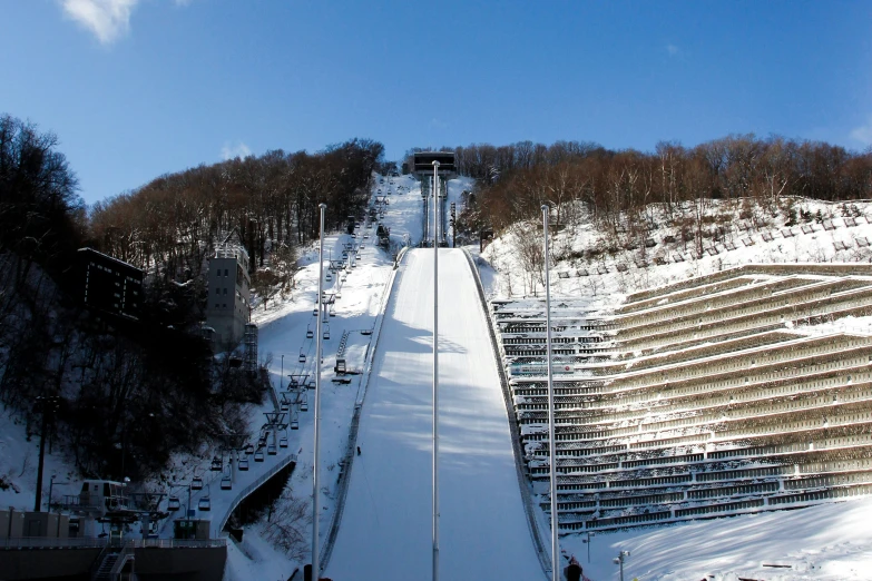 a ski lift going up a mountain during the day