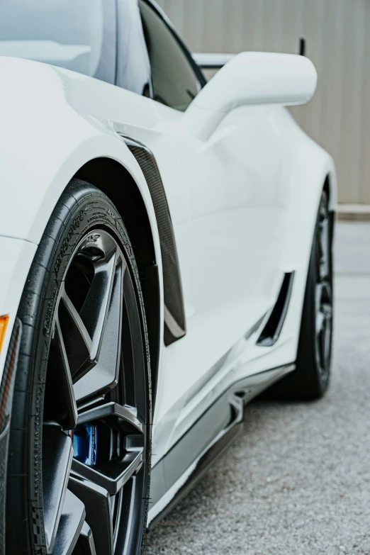 this white corvette sports car is parked on asphalt