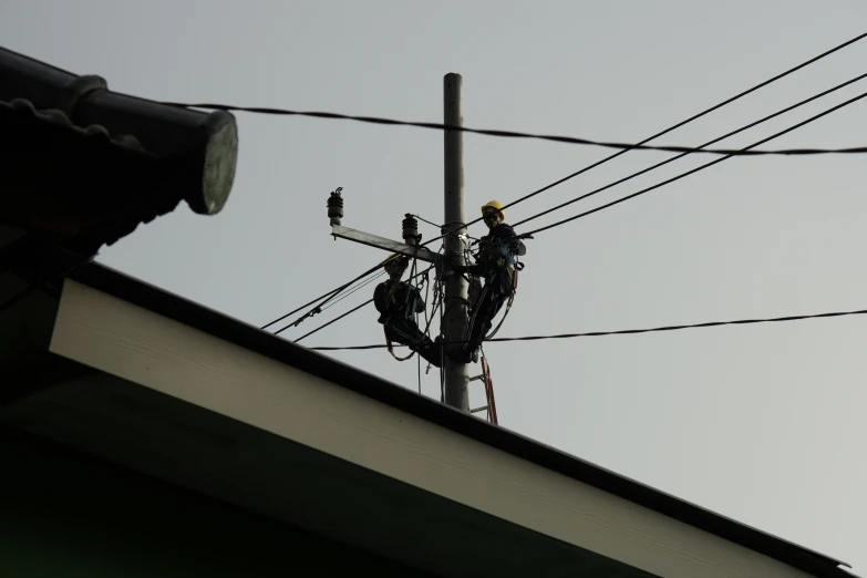 a power line has some wires and an electrical pole