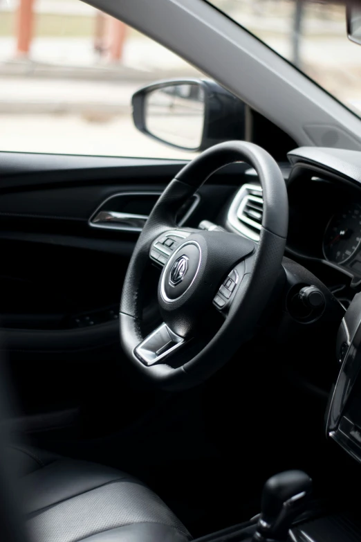 steering wheel and dashboard in the interior of a small car