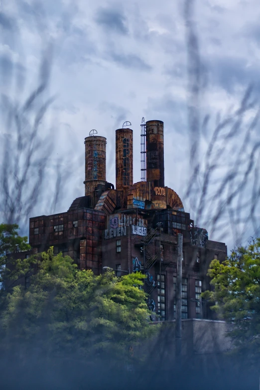 an old factory with chimneys that are smoking