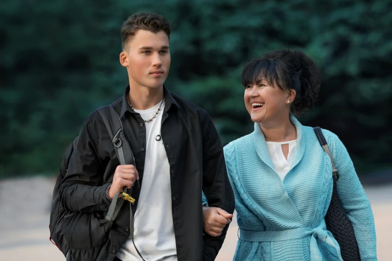 a man and a woman walk together holding hands