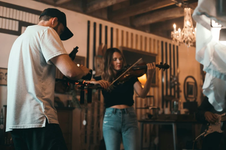 a man is playing violin with a woman