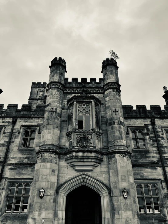 a large gothic style building on a cloudy day