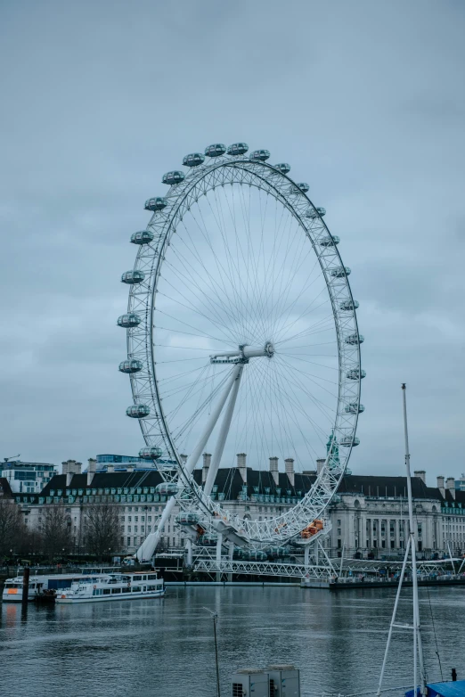 the large ferris wheel sits over the water