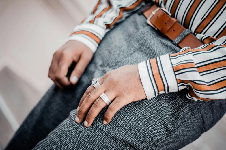 a close up of a person wearing a belt and shirt