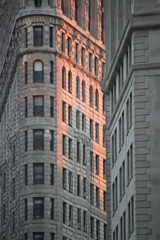 a red building lit up with the light reflecting off it's windows