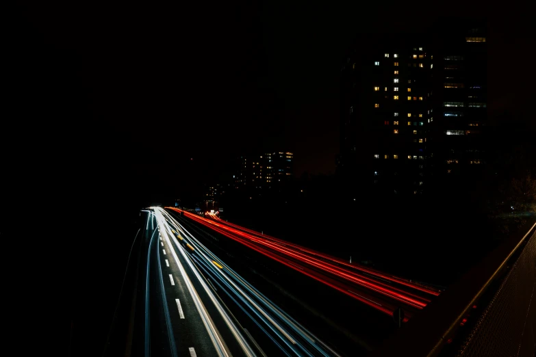 an aerial view of a highway and light trails at night