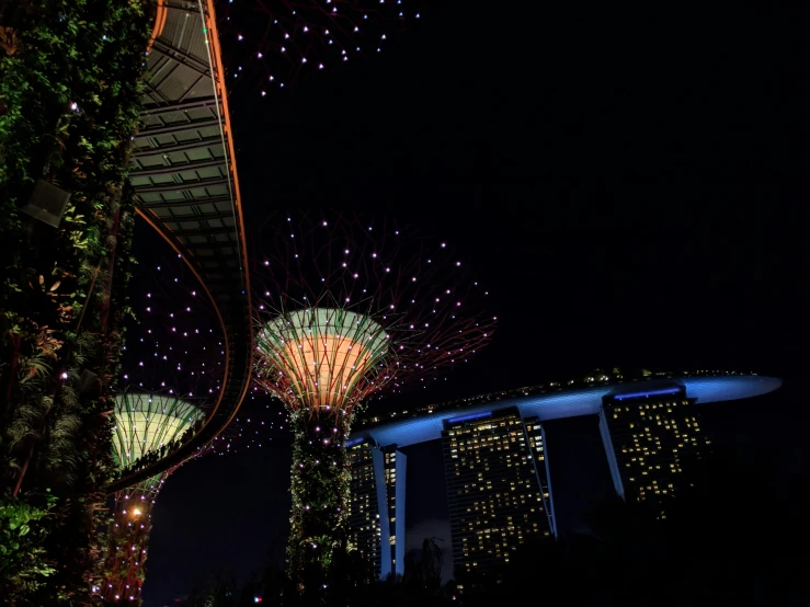 the lights shine on a tall building in a city at night