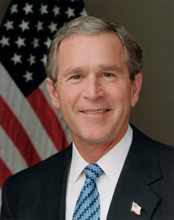 a man in a suit and tie is smiling at the camera