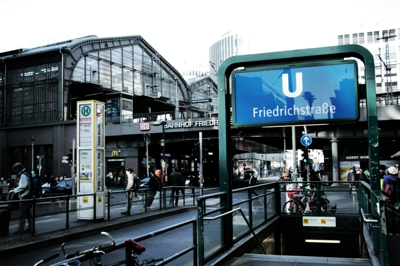 a train station with some people and bikes