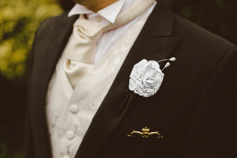 a groom dressed in a suit and with boutonniere