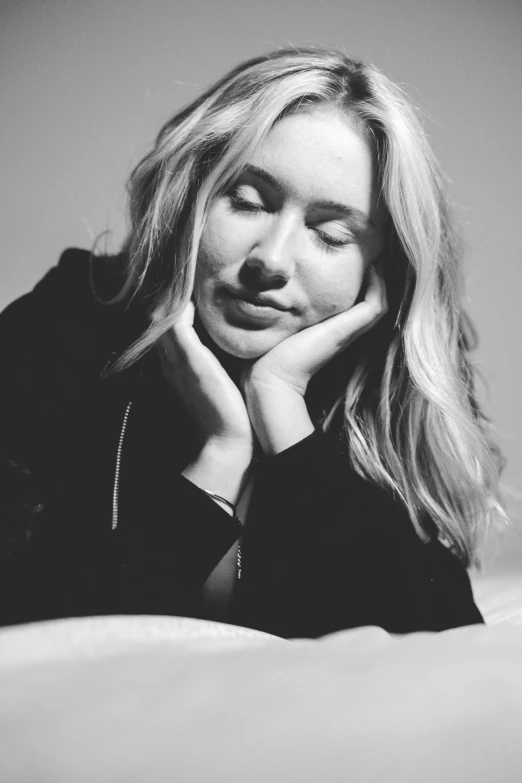 black and white pograph of a beautiful blond woman sitting on the floor