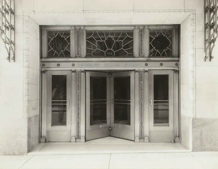 an old building with a double entry and decorative glass window