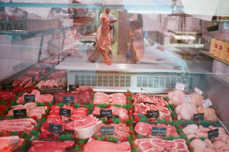 butchers stand in a butcher shop with their display meat